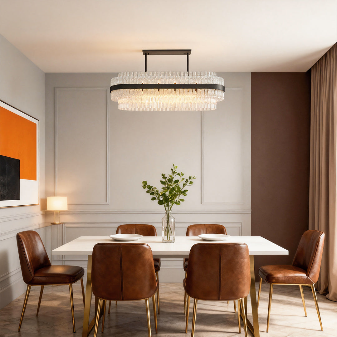 Industrial modern chandelier in spacious dining room with brown leather chairs and orange accent art