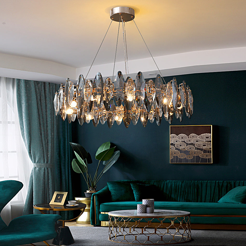 Luxurious chandelier with crystals illuminating a modern living room with dark green walls.