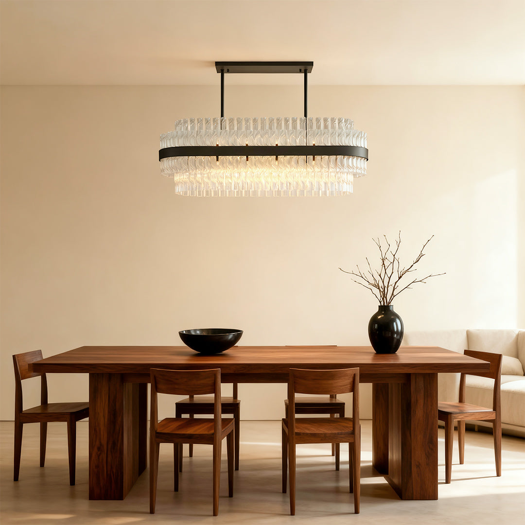 Modern luxury chandeliers mounted above wooden dining table in minimalist beige setting
