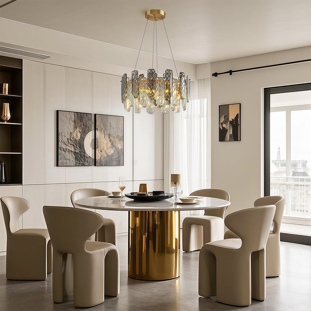 Luxury contemporary crystal chandeliers above circular dining table in sophisticated neutral interior.