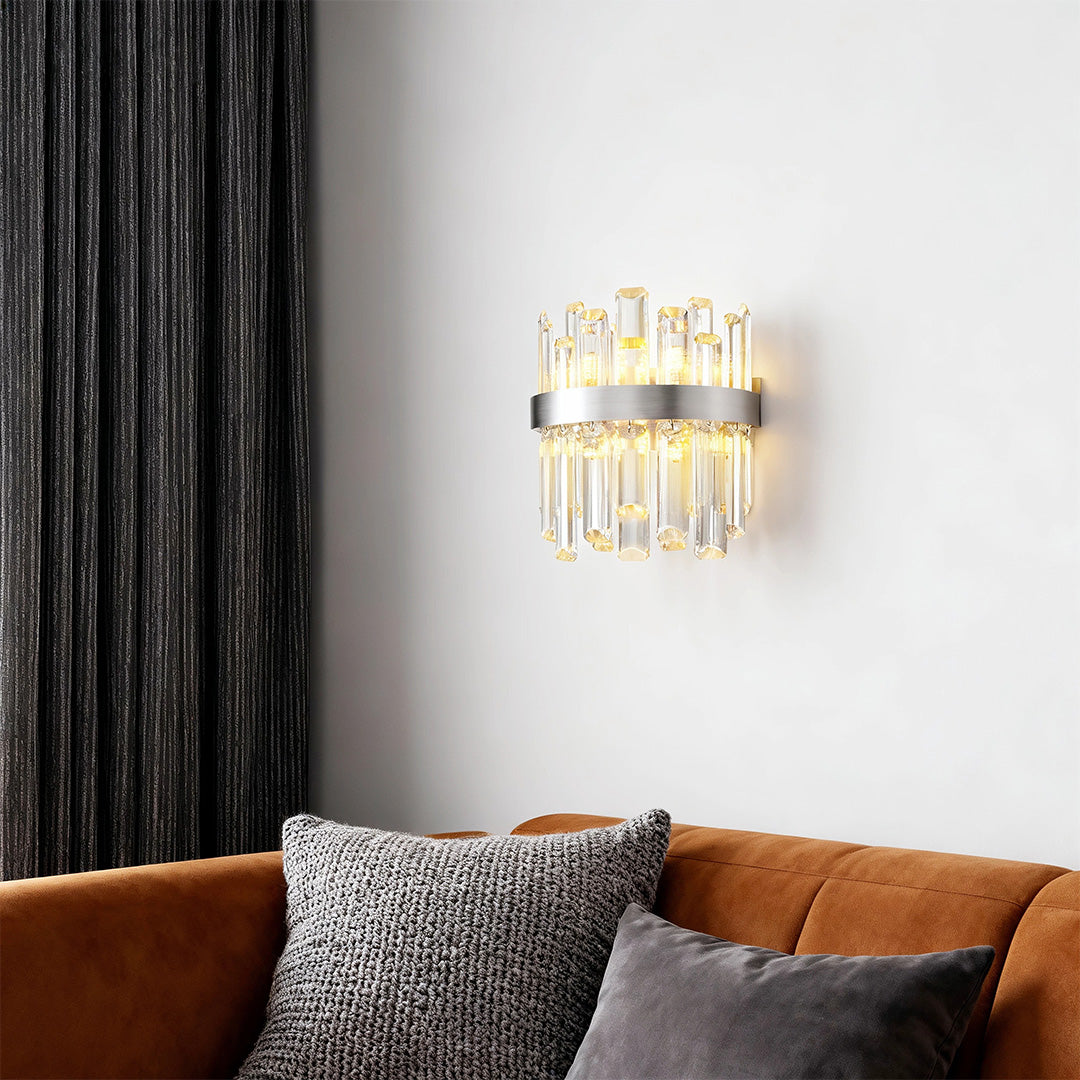 Luxury crystal chandelier above contemporary sofa with animal print pillows and black curtains