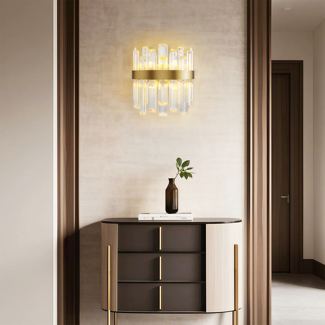 Luxury crystal chandelier illuminating elegant entryway with dark wood console and modern decor