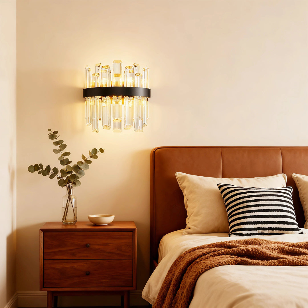 Modern luxury chandeliers illuminating warm bedroom with wooden furniture and orange leather headboard