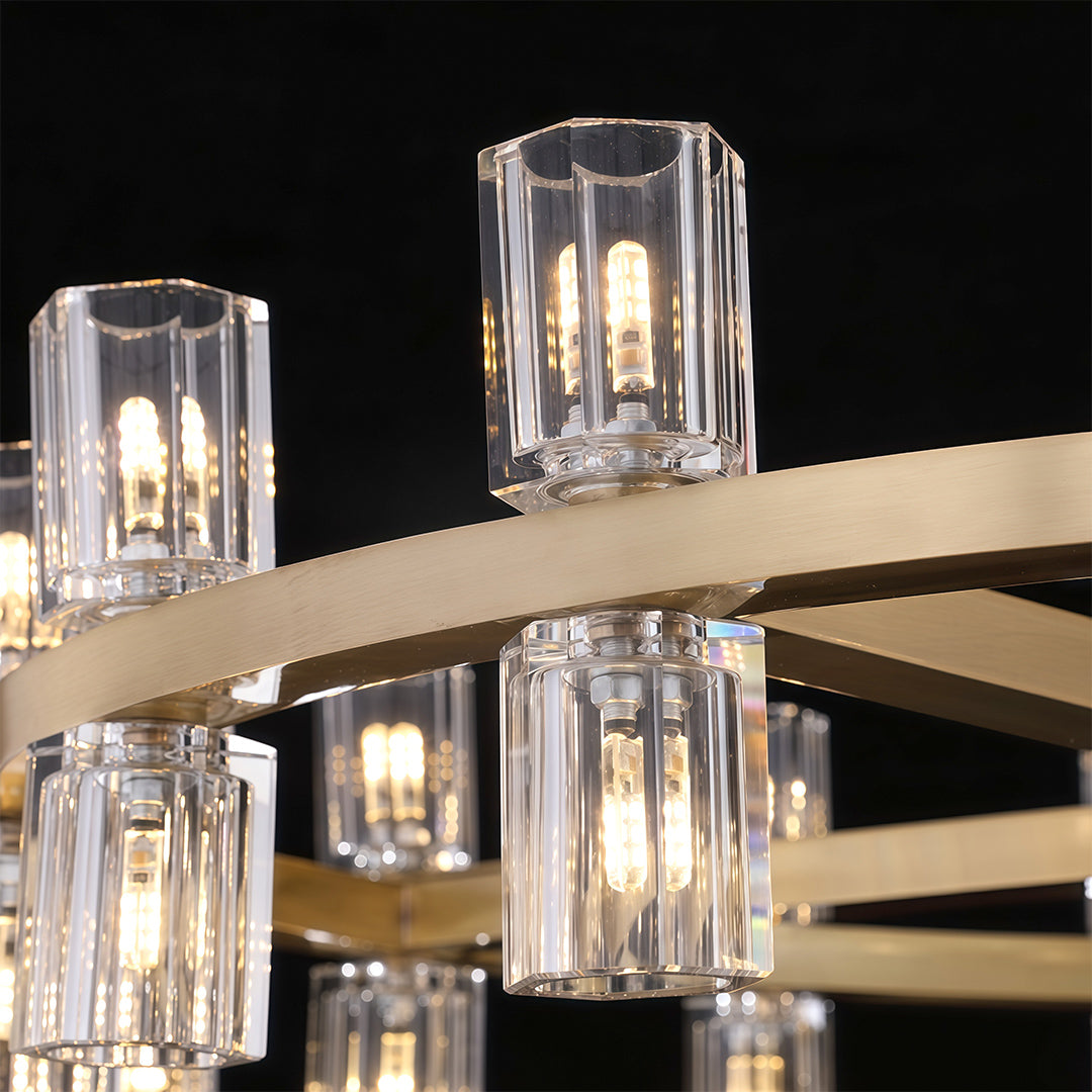 Luxury crystal chandeliers close-up detail showcasing clear glass cylinders and brass hardware.