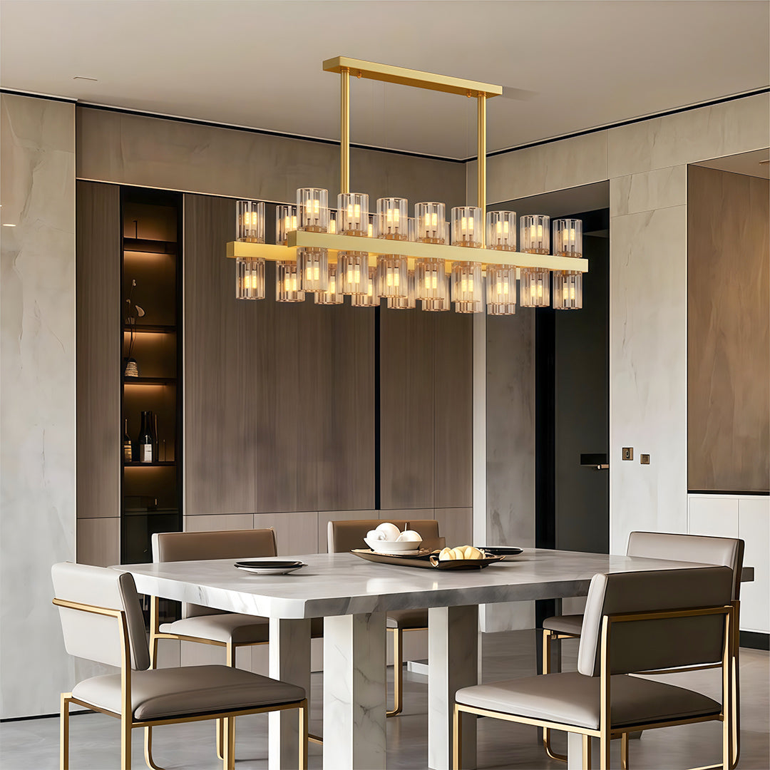Luxury crystal chandeliers illuminating contemporary dining room with marble table and grey chairs.