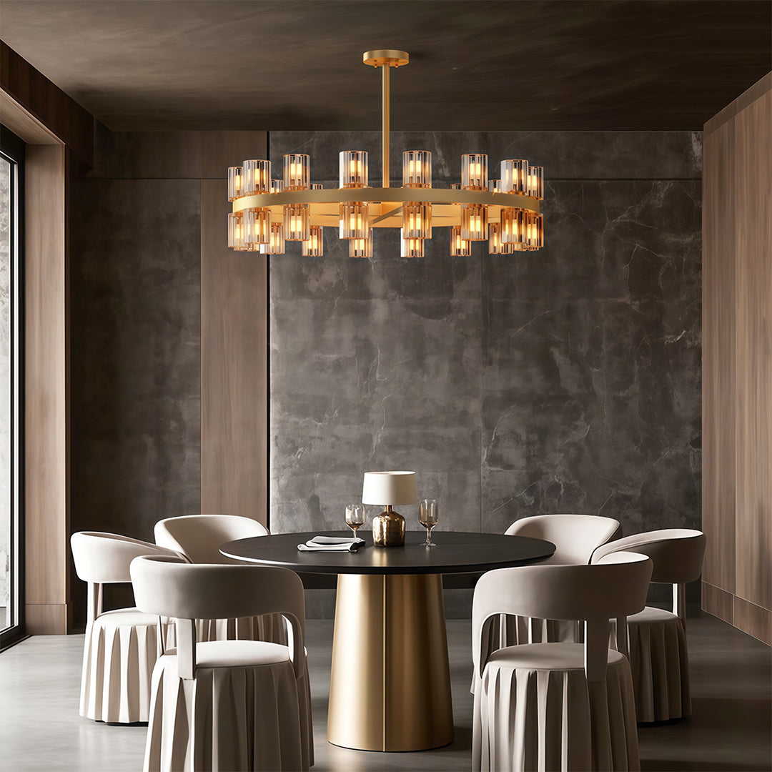 Luxury crystal chandeliers lighting intimate dining area with round brass table.