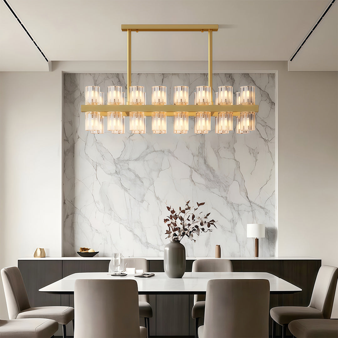 Luxury crystal chandeliers illuminating minimalist dining room with marble feature wall.