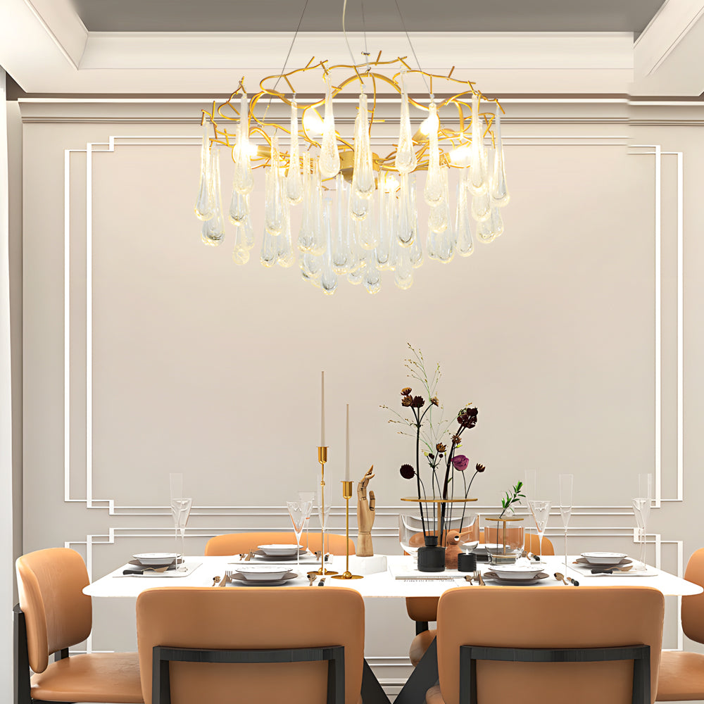 Luxury crystal modern chandelier over a modern dinner set with warm ambient lighting.