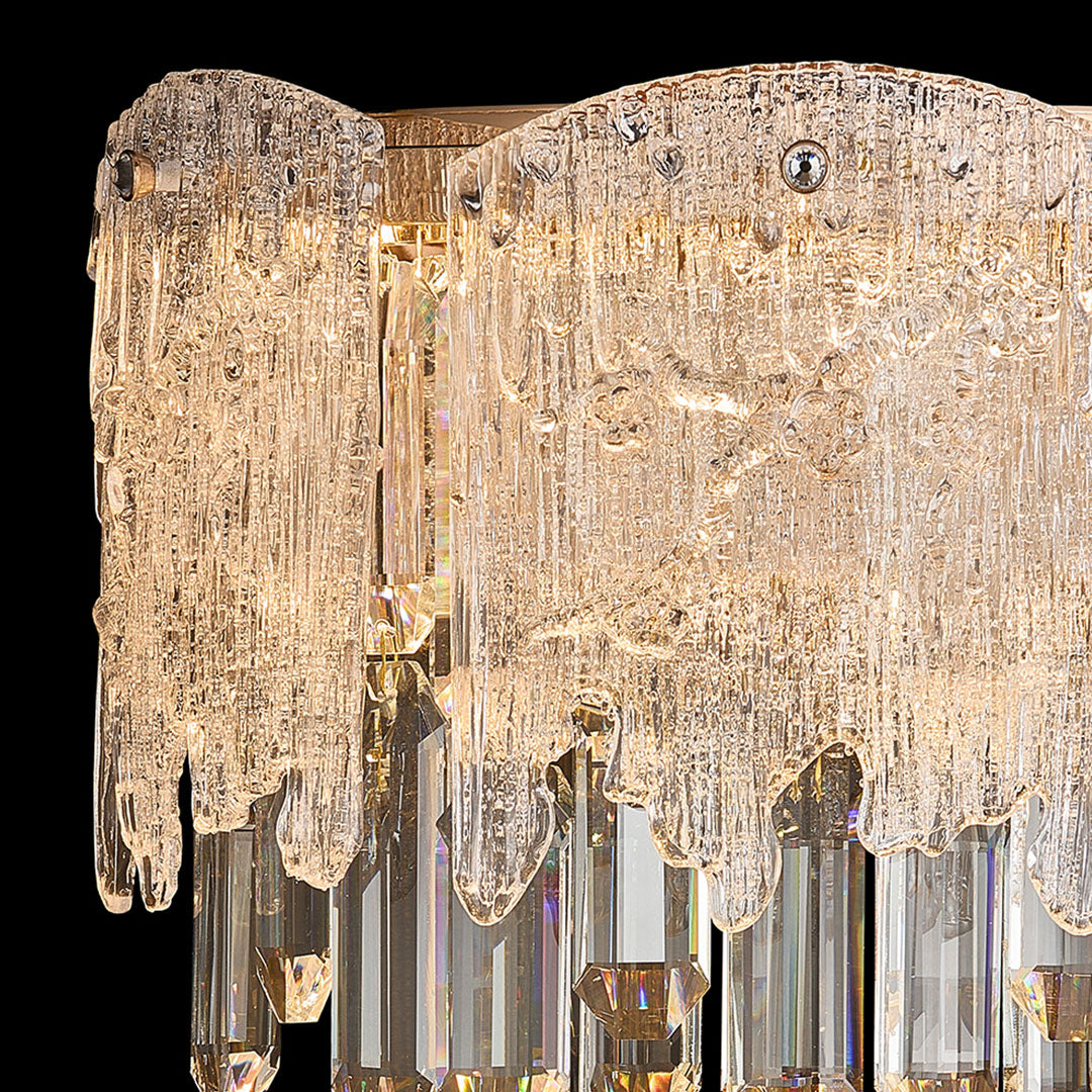 Detailed view of gold frame and layered crystals on luxury wall sconce lighting.