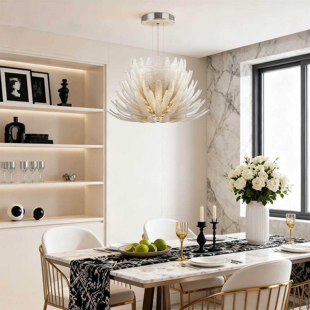Luxury deco chandelier hanging in bright white dining space.