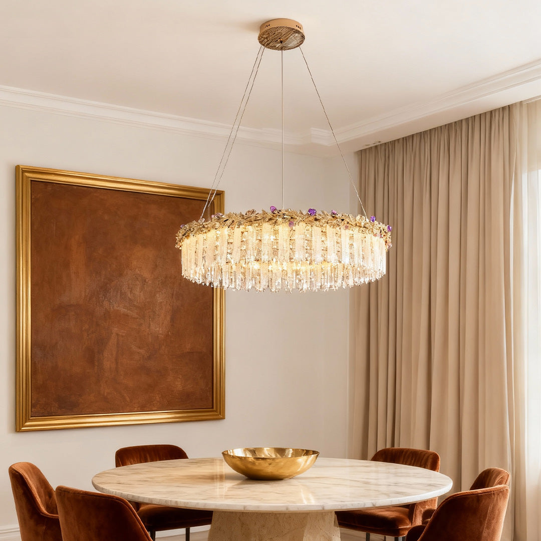 Luxury dining room featuring gold chandelier crystal and elegant table setting.