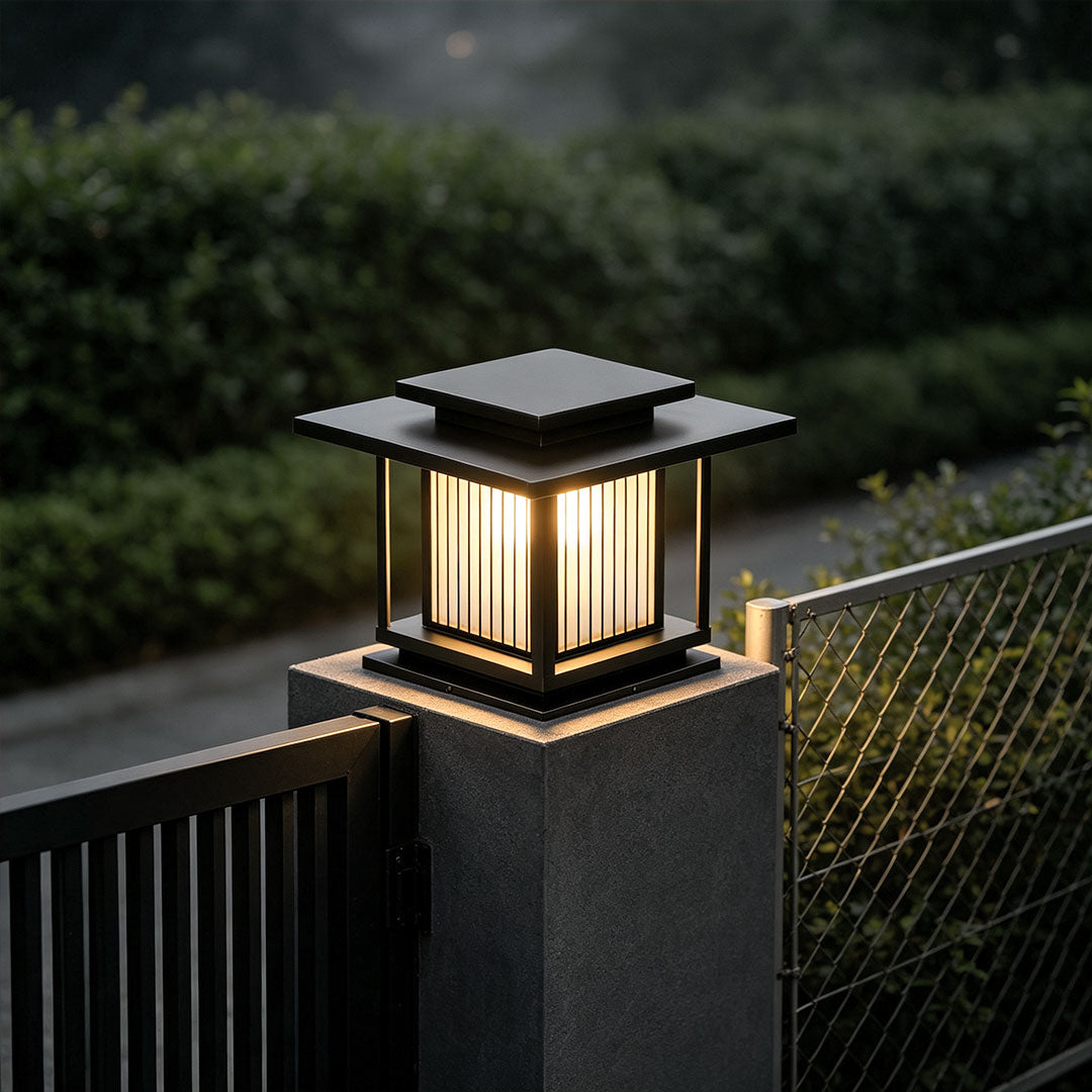 Luxury villa entrance illuminated by driveway pillar solar lights mounted on tall gate columns.