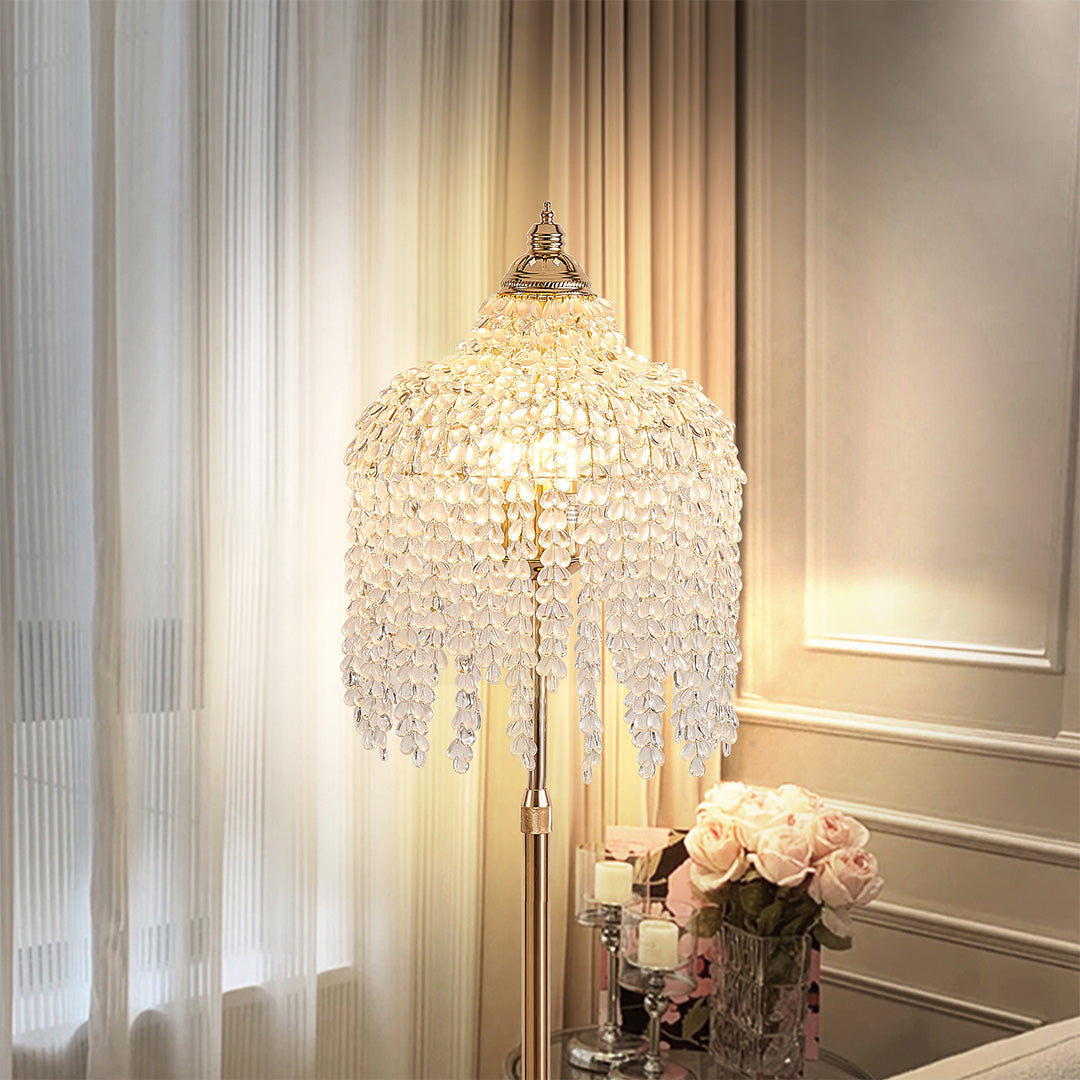 Tall gold teardrop floor crystal lamps near window, featuring shimmering crystals for a touch of sophistication.