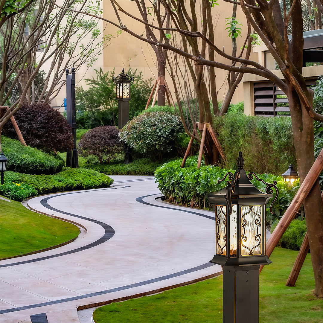 Luxury landscape post lights installed beside stone pathway, enhancing upscale garden design.