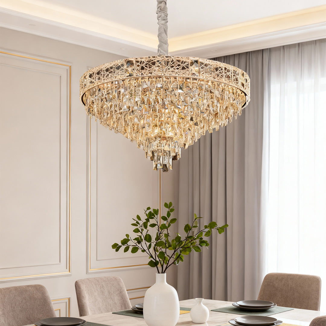 Luxury gold crystal chandelier with faceted teardrops above elegant dining table.
