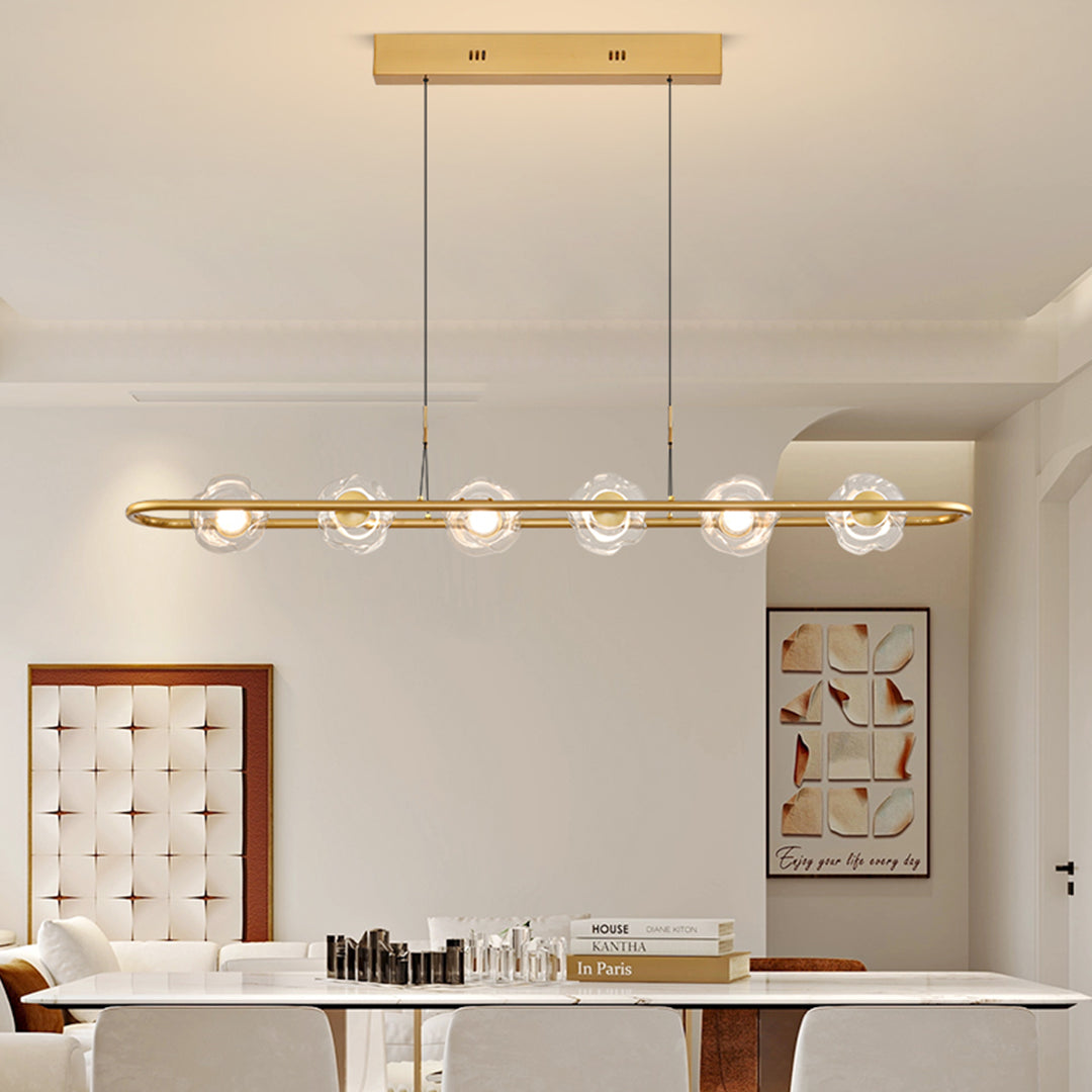 Luxury rise and fall pendant light with gold finish creating ambient lighting over dining table
