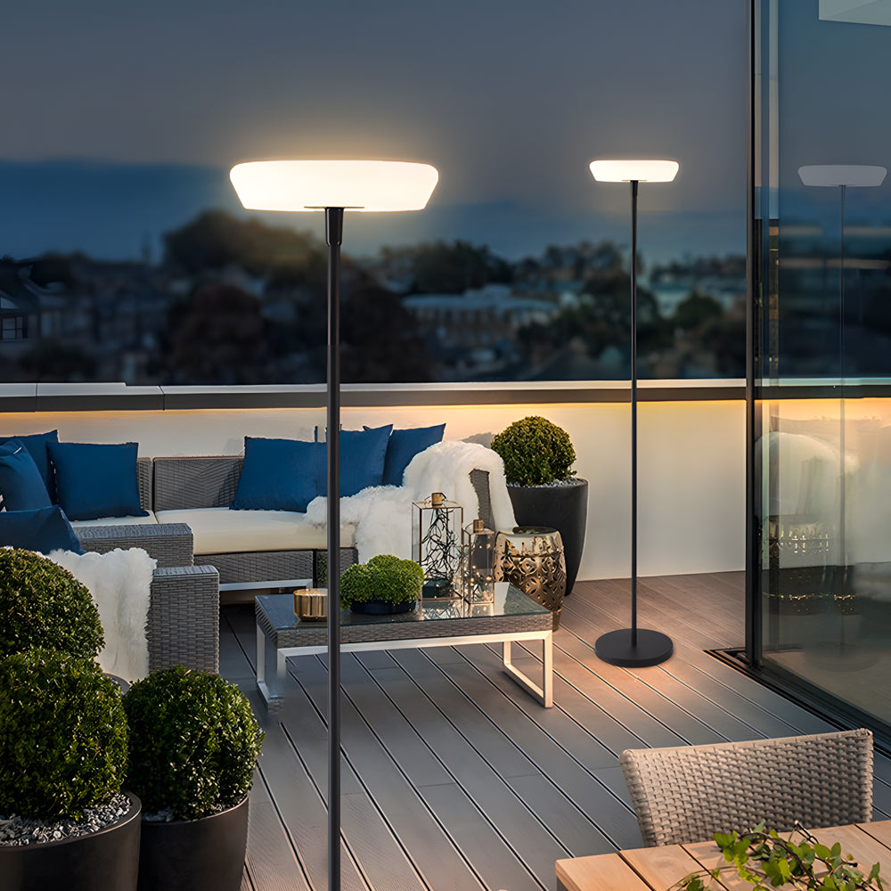 Elegant halo floor lamp illuminating luxury outdoor terrace with city skyline view and contemporary furniture setting