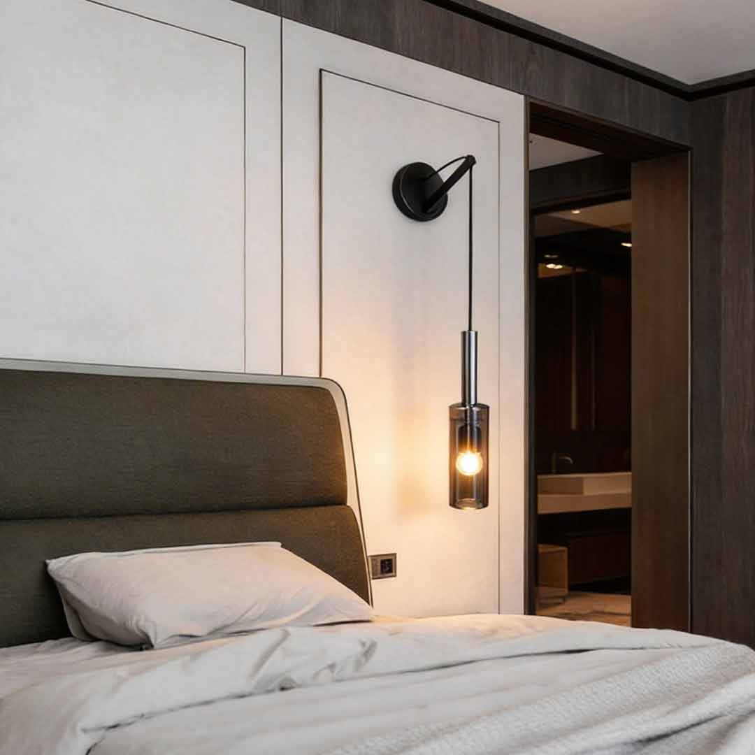 Luxury interior design featuring a black and gold bedside hanging wall lamp next to a large upholstered bed.