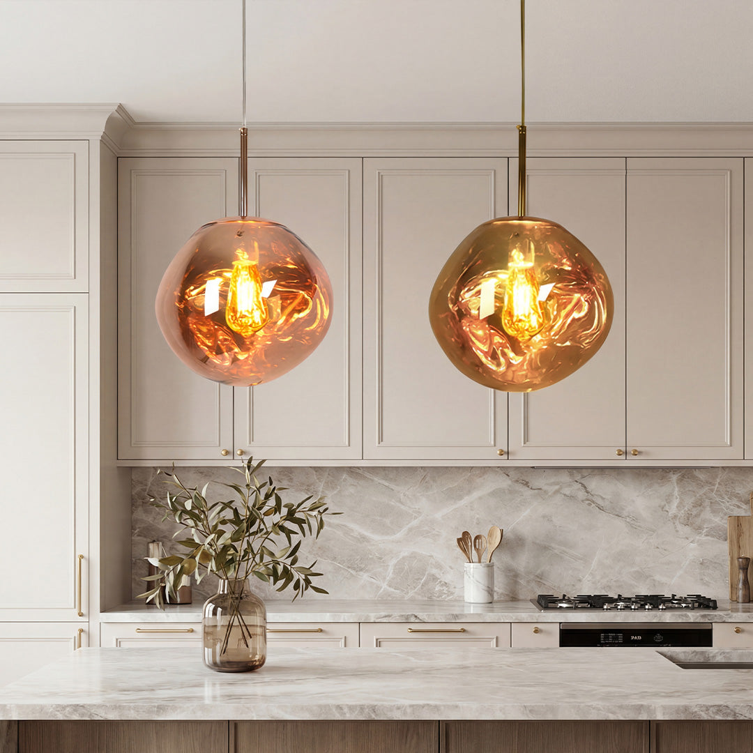 Stunning Melt pendant light duo in copper and gold over a luxury marble kitchen island desk.