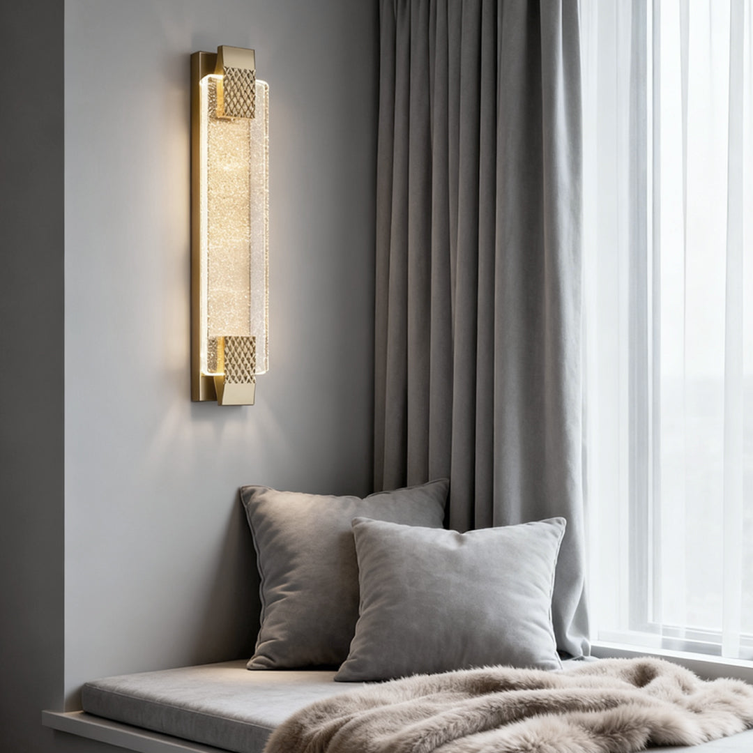 Luxury modern wall lights illuminating a cozy living room nook with a sofa and soft throw pillows.