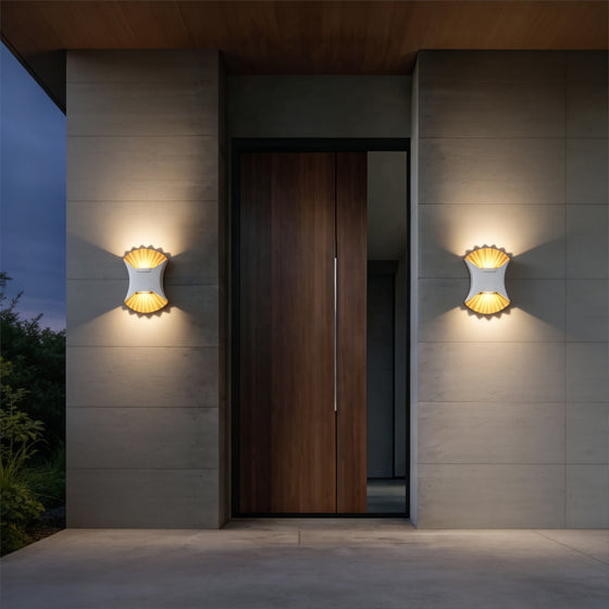 Luxury home entrance illuminated by outdoor up down wall light with warm decorative lighting effect.