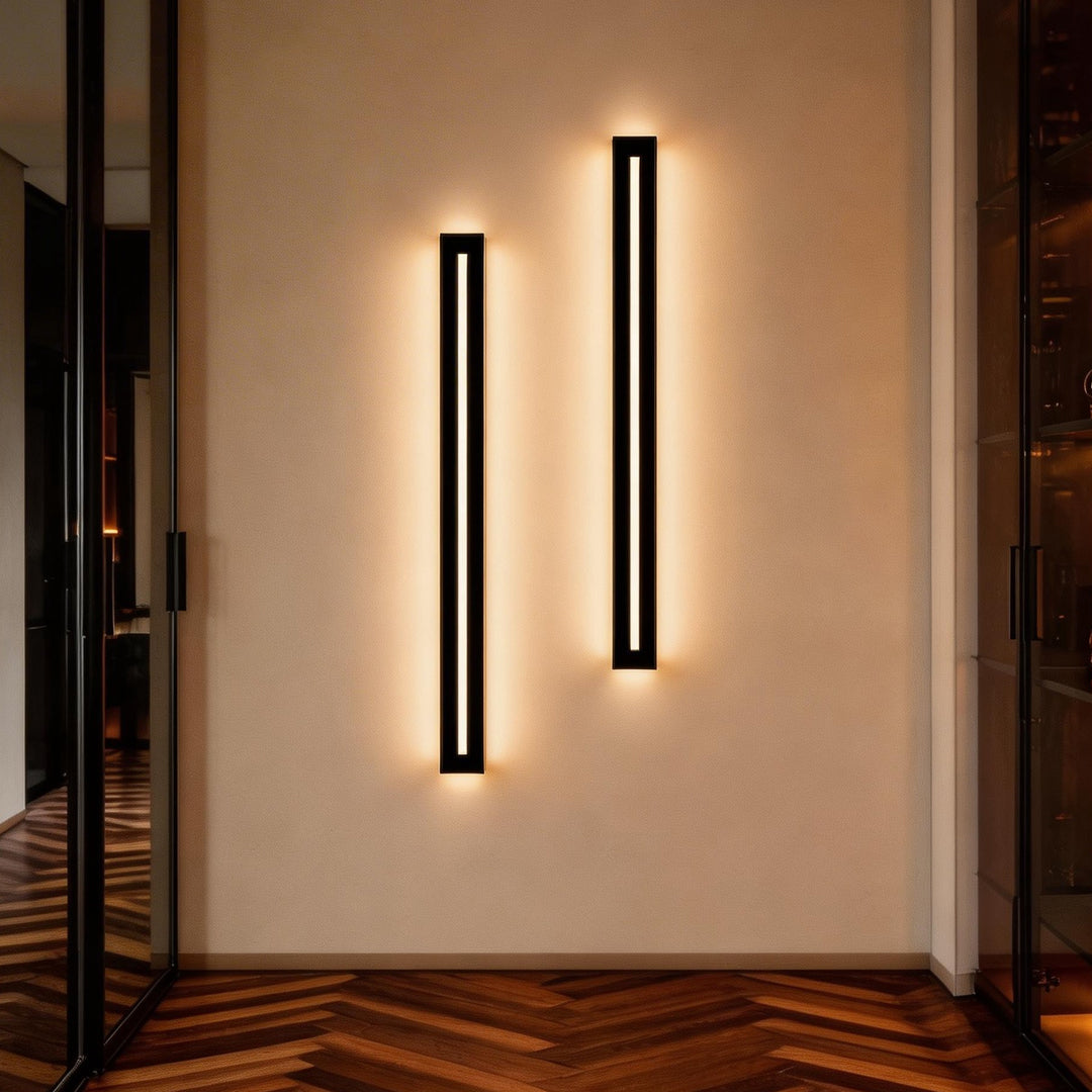 Pair of luxury long black wall sconces mounted on a hallway wall.