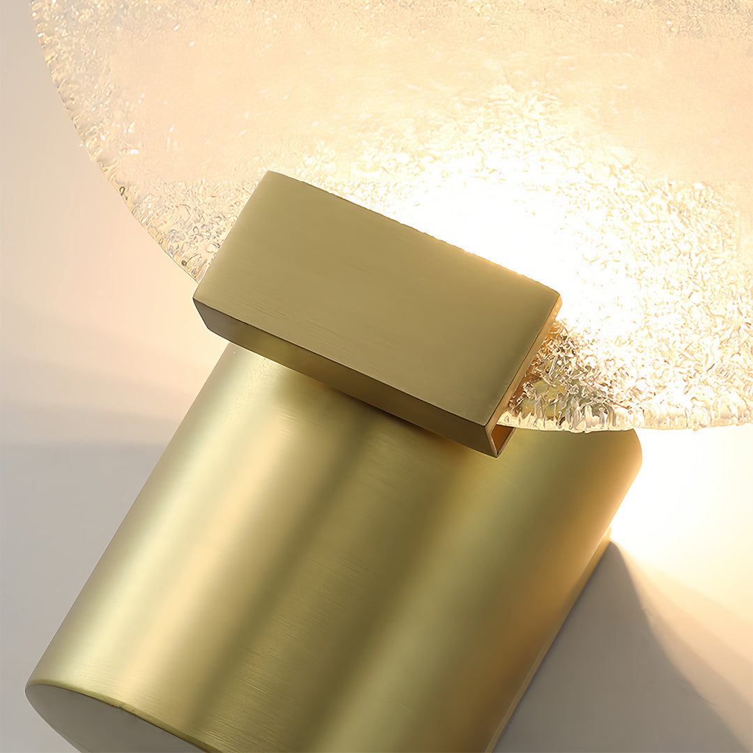 Luxurious brass and glass wall lights with crystal-like ribbed design and metallic gold accents