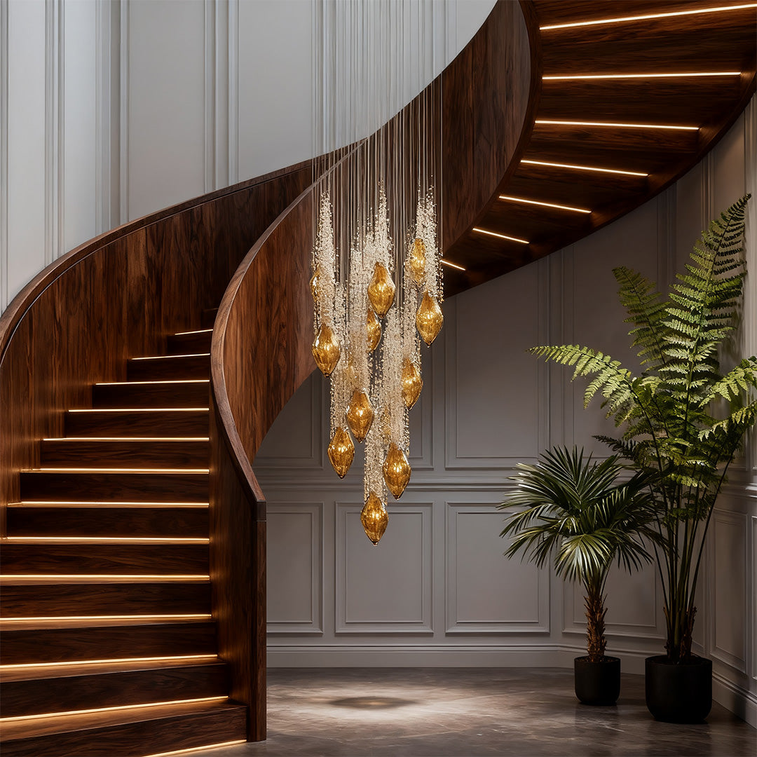 Amber glass stairway chandelier hanging above curved wooden staircase.