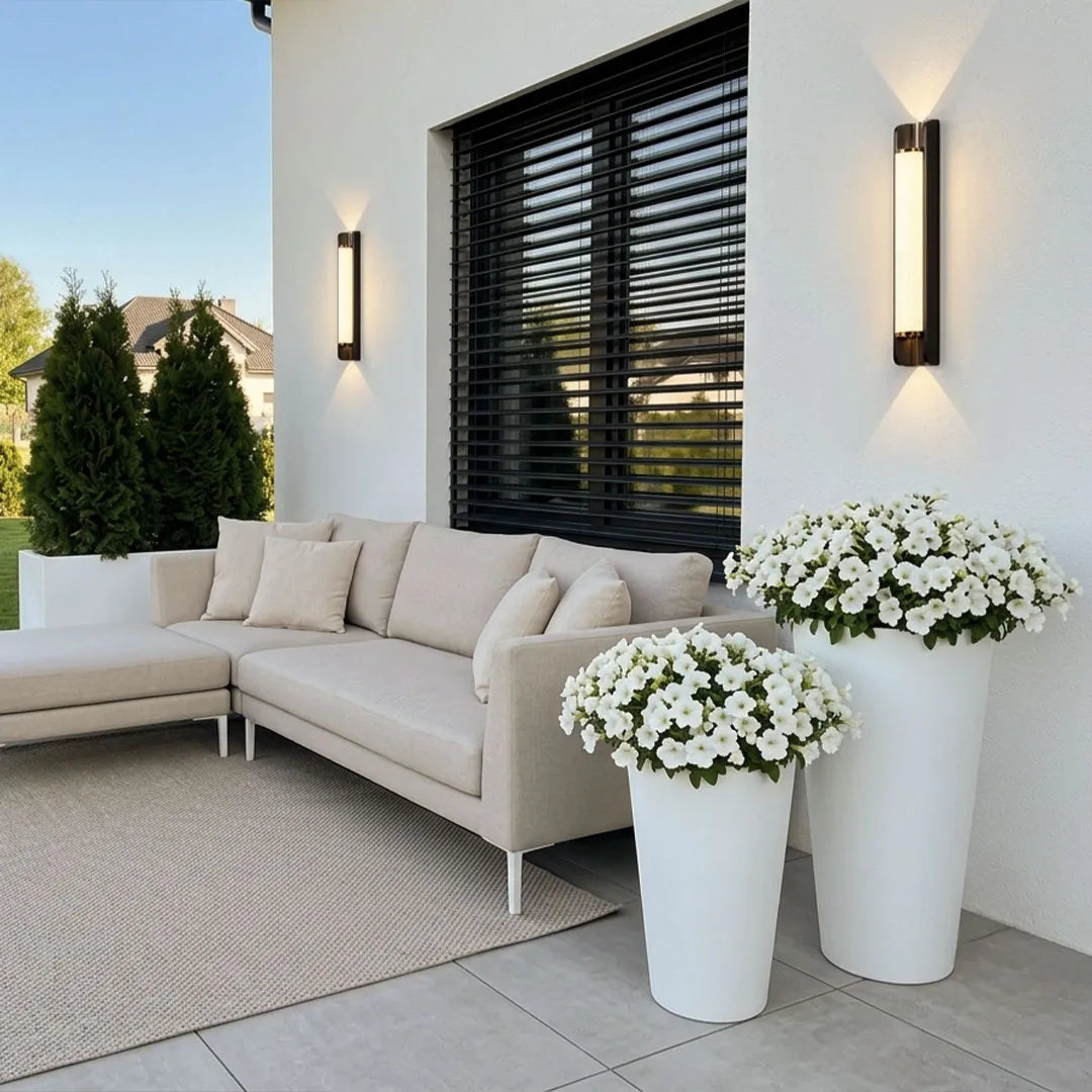 Luxury up down outdoor wall sconce enhancing an elegant home facade at night.