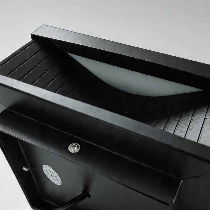 Macro detail of the black textured finish and internal diffuser of square outdoor pillar light.