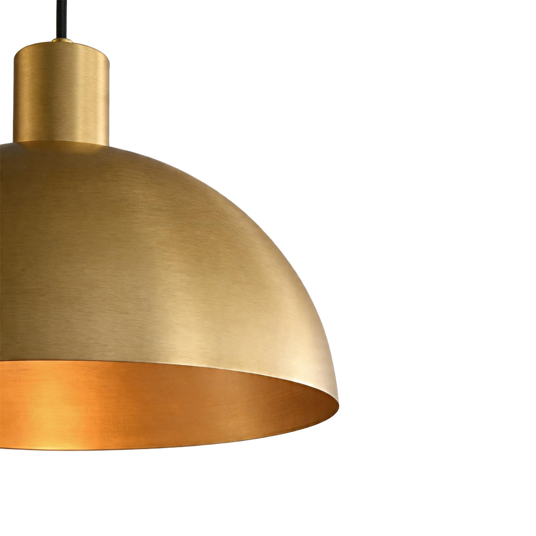 Macro detail of the brushed brass pendant lighting dome shade showing the metallic texture ok.
