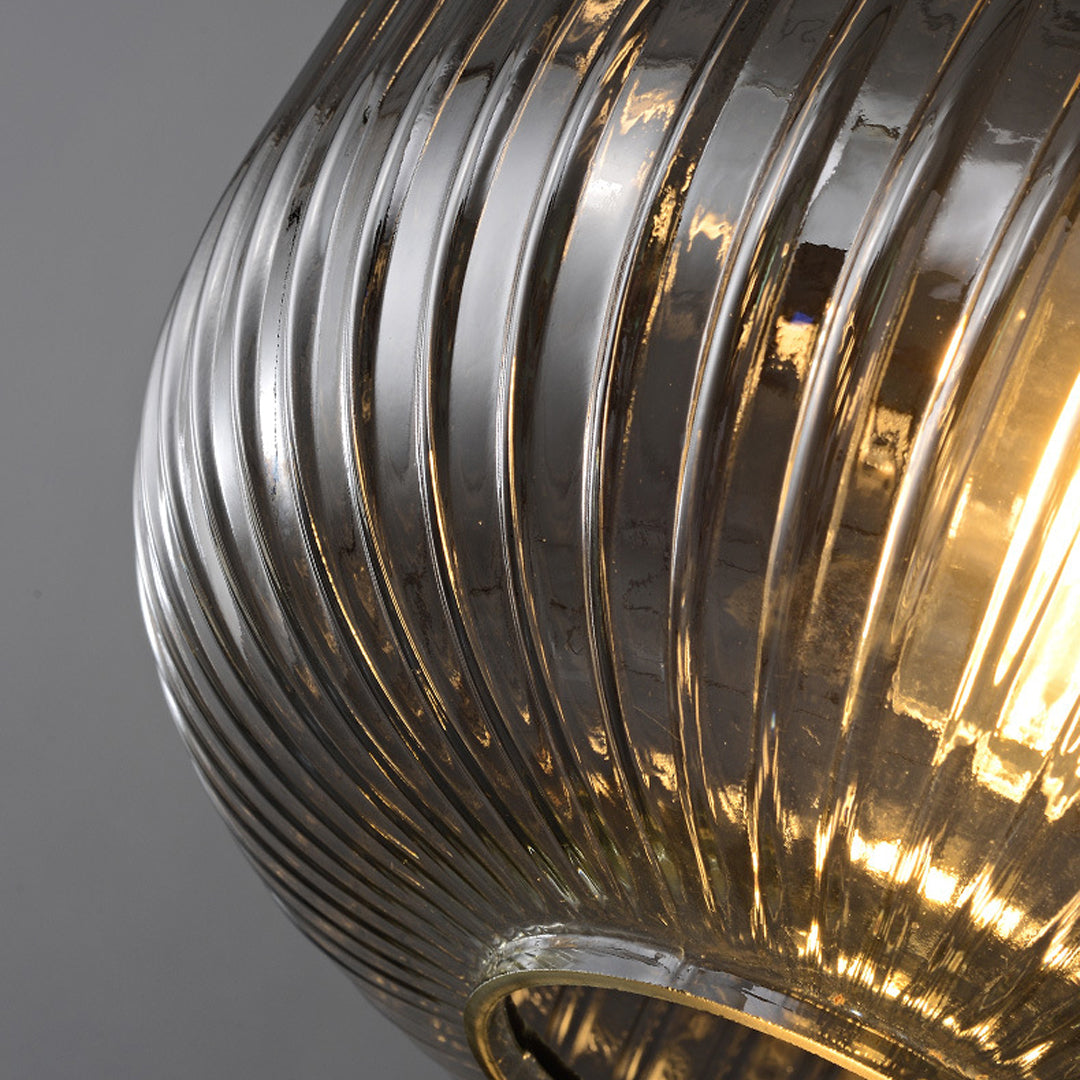 Macro detail of the ribbed texture and internal warm glow of a vintage glass pendant light shade