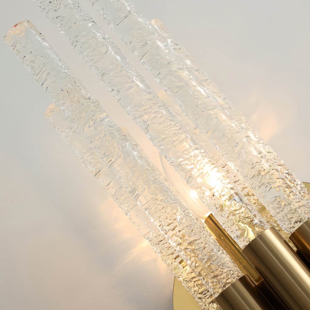 Macro detail of textured glass tubes on a modern crystal wall light showing the internal glow.