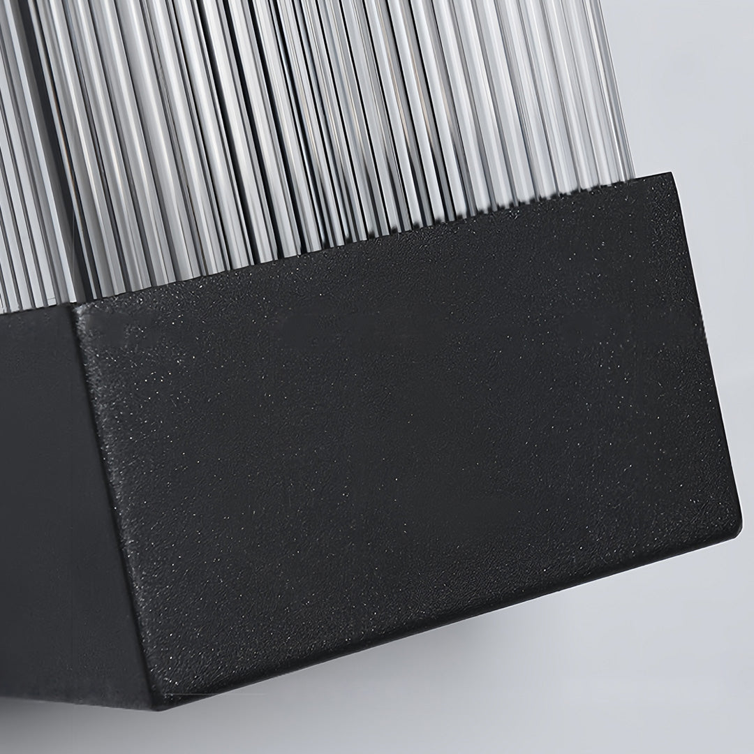 Macro shot showcasing the textured black metal finish on the base of the linear outdoor sconce.