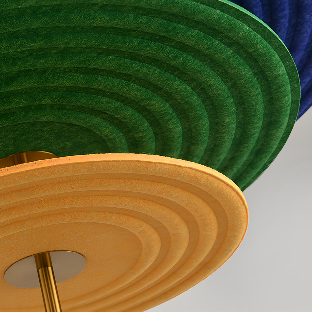 Macro shot showing the texture of the green and yellow tiered felt components of a unique 3 tier chandelier.