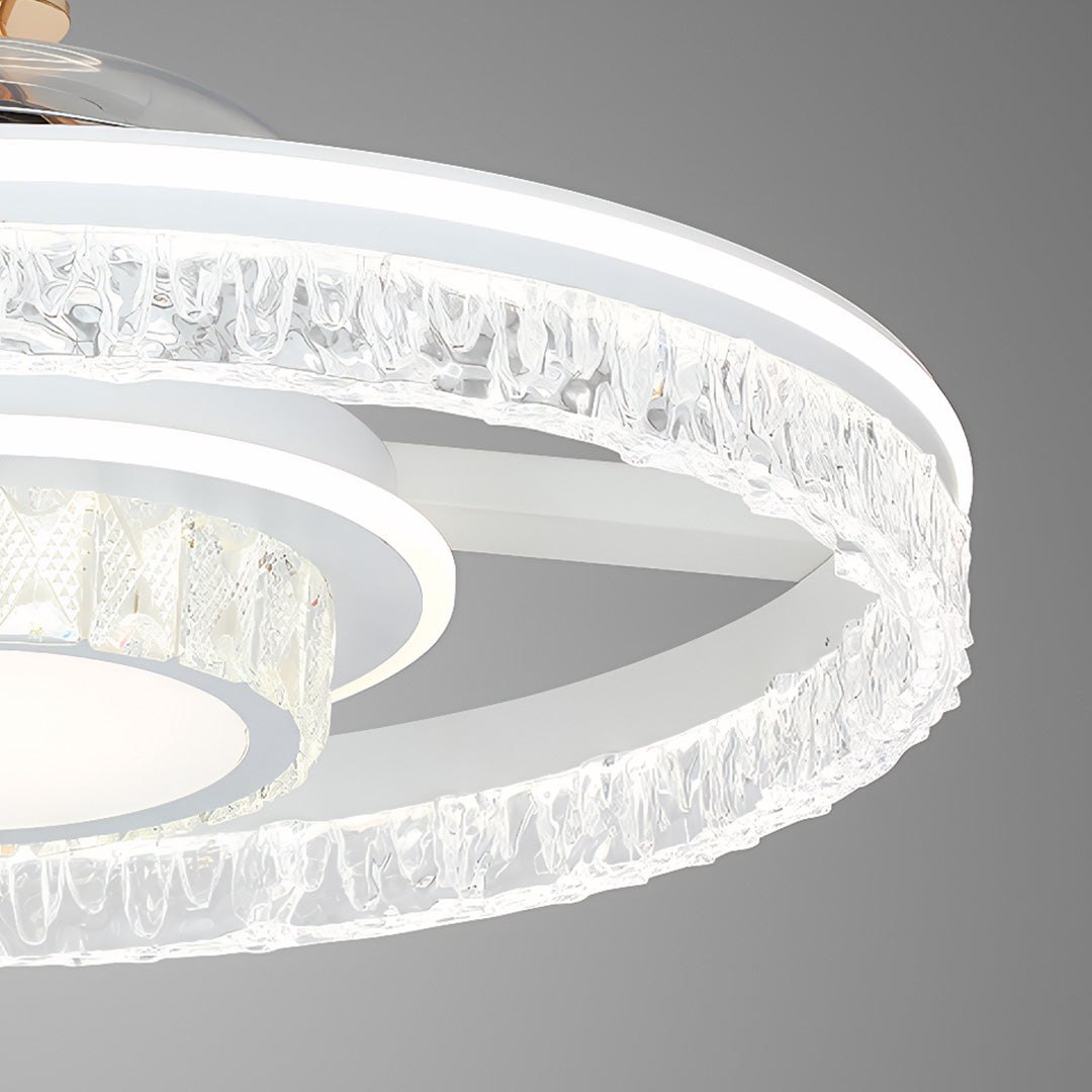 Detailed macro view of the ceiling fan with round light's illuminated crystal-encrusted outer band and diamond-cut texture. 