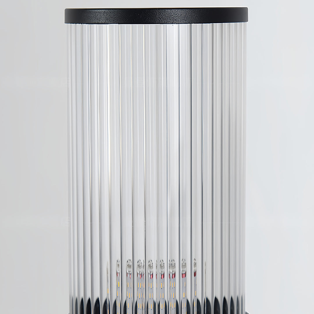 Macro view of the clear, vertically fluted glass diffuser on the contemporary bollard path light.