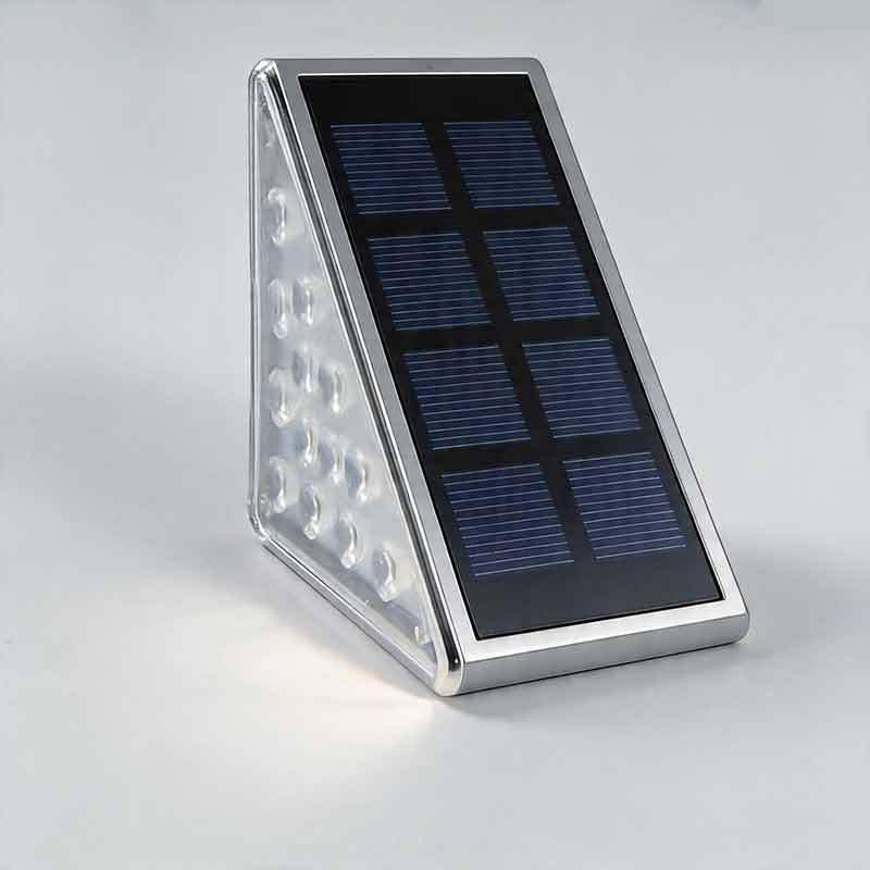 Macro view of multiple LED beads on triangular solar powered lights for steps with silver frame.