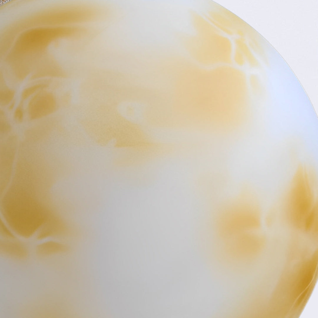 Detailed macro view of the marble texture on a moon-shaped stone pillar light surface close up.