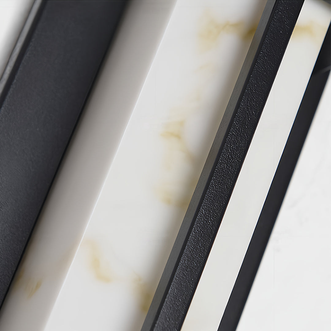 Detailed macro view of the white marbled diffuser panel set within the black outside wall lights.