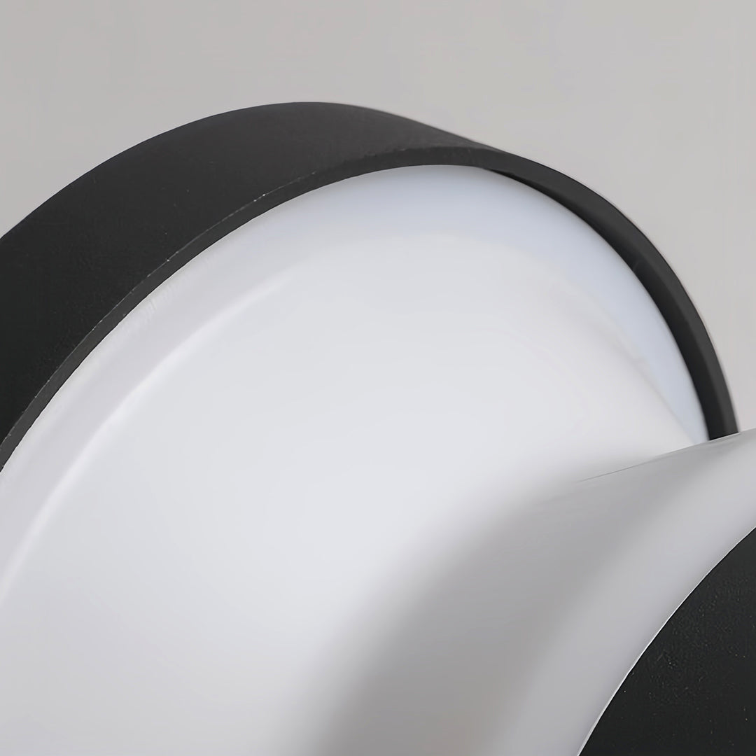 Detailed macro view of the seamless transition between the dark metal base and the curving white diffuser on the modern path lights.