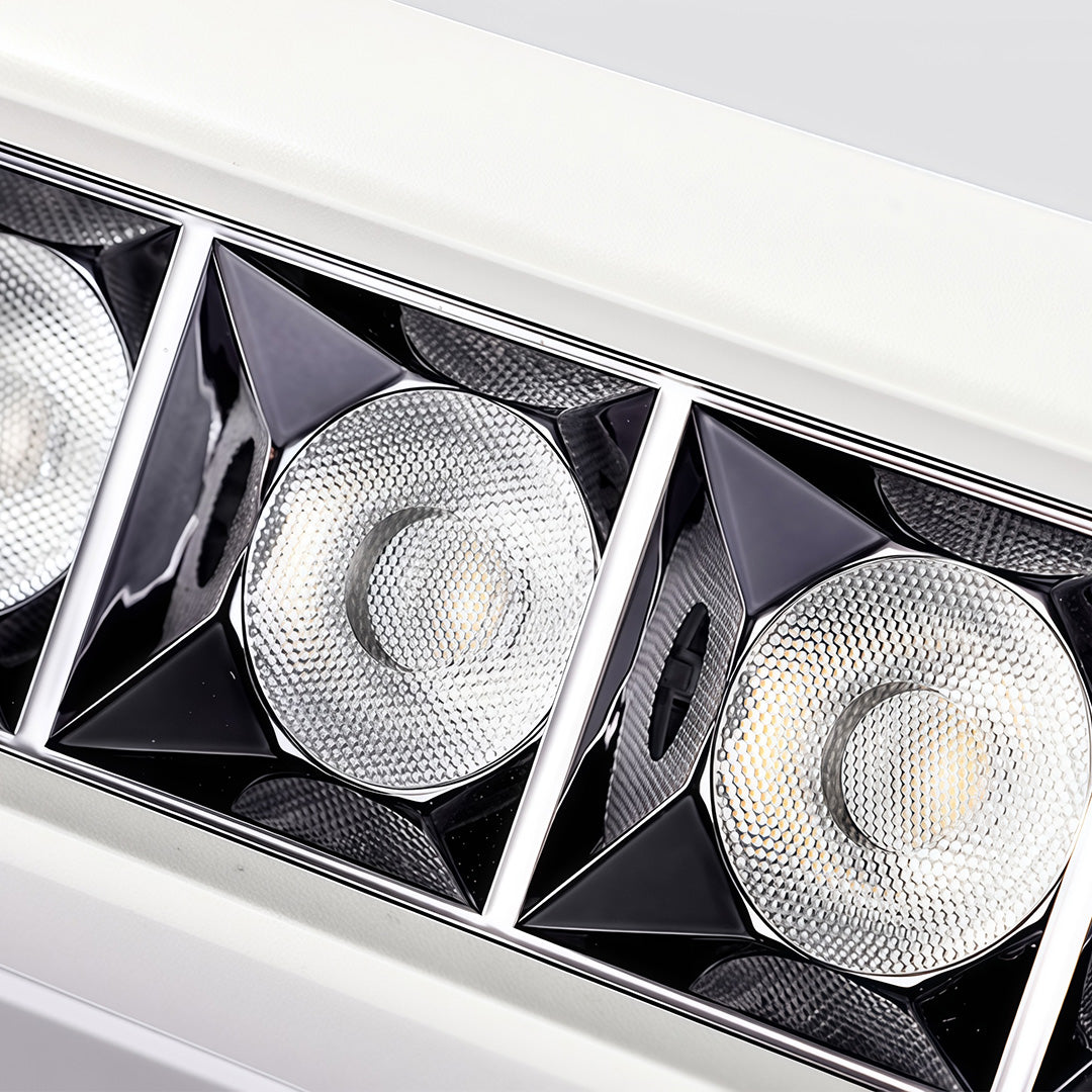 Detailed macro view inside a white square downlights fixture, highlighting the multiple COB LEDs and textured baffles.