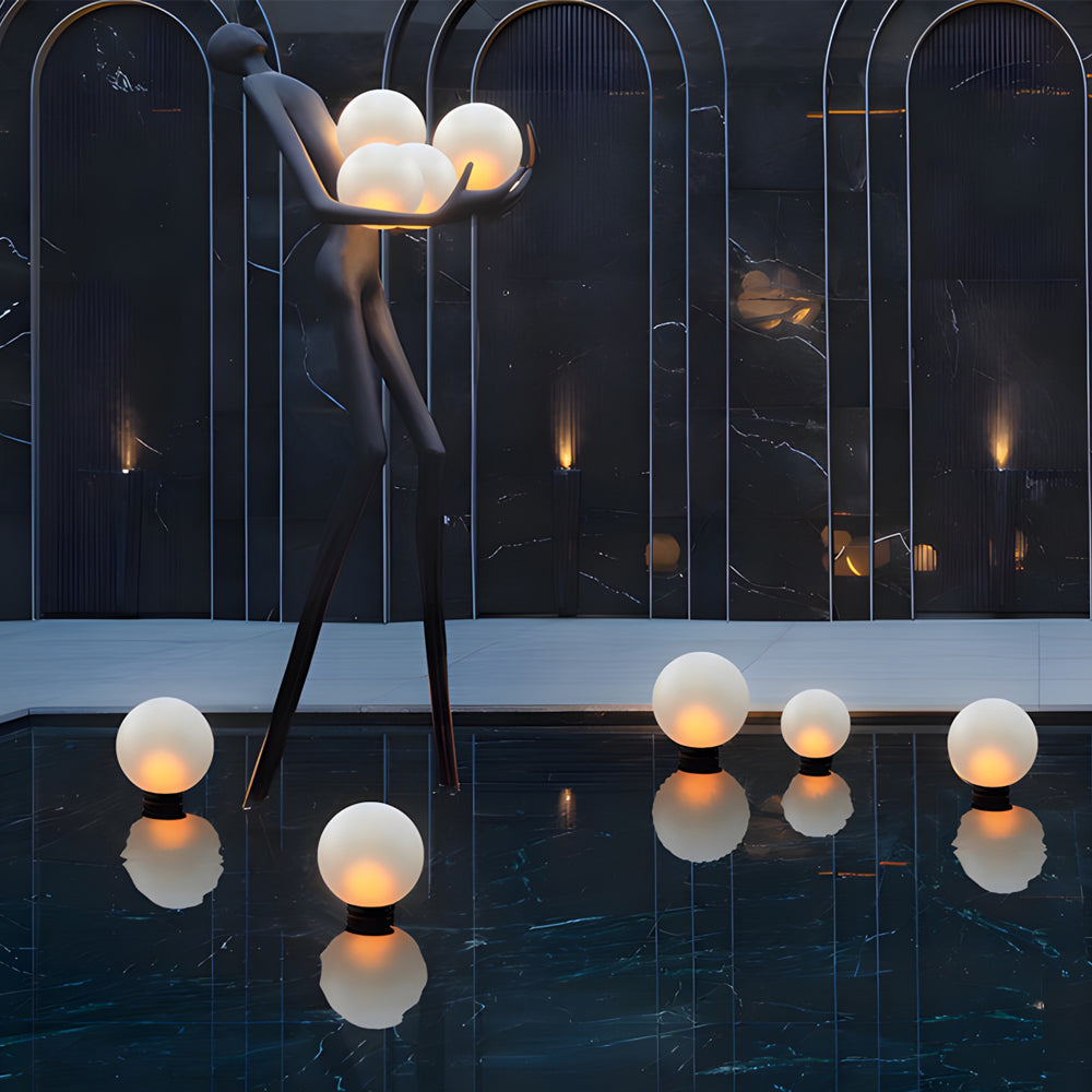 Silver Metal Table Lamp round globe lights creating magical evening atmosphere on modern outdoor terrace with contemporary architecture