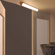 Magnetic motion sensor light illuminating a modern closet with wooden shelves and hanging clothes.
