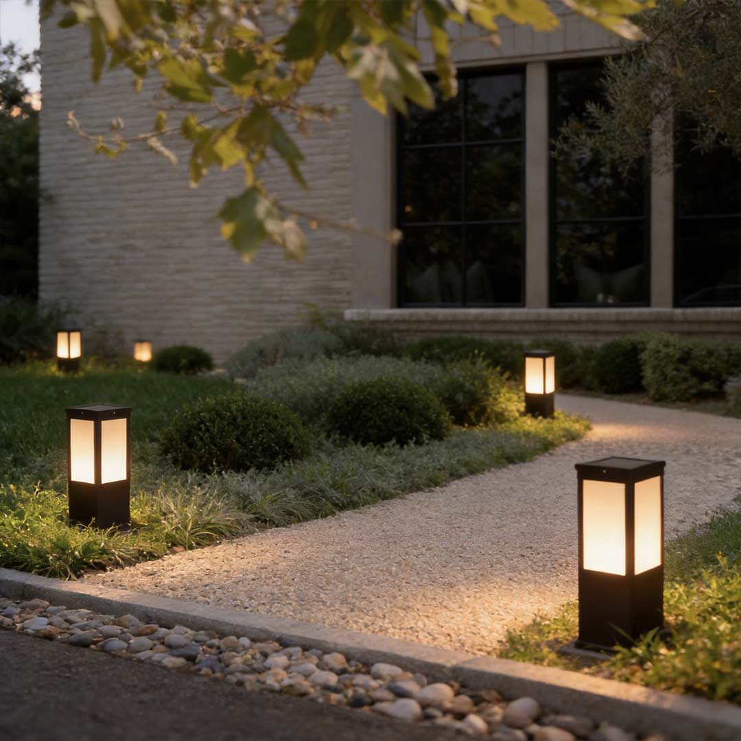Mainstays bollard pathway light illuminating a modern garden walkway with warm directional glow.