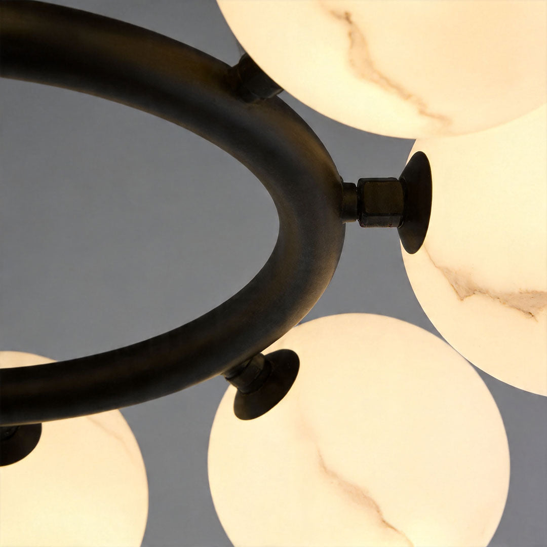 Detailed view of marble-textured glass globes on a modern bubble chandelier with soft glow.