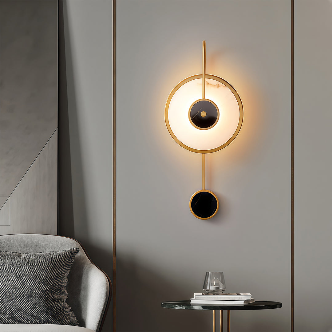 Marble wall light installed in modern bedroom creating ambient glow with circular brass fixture