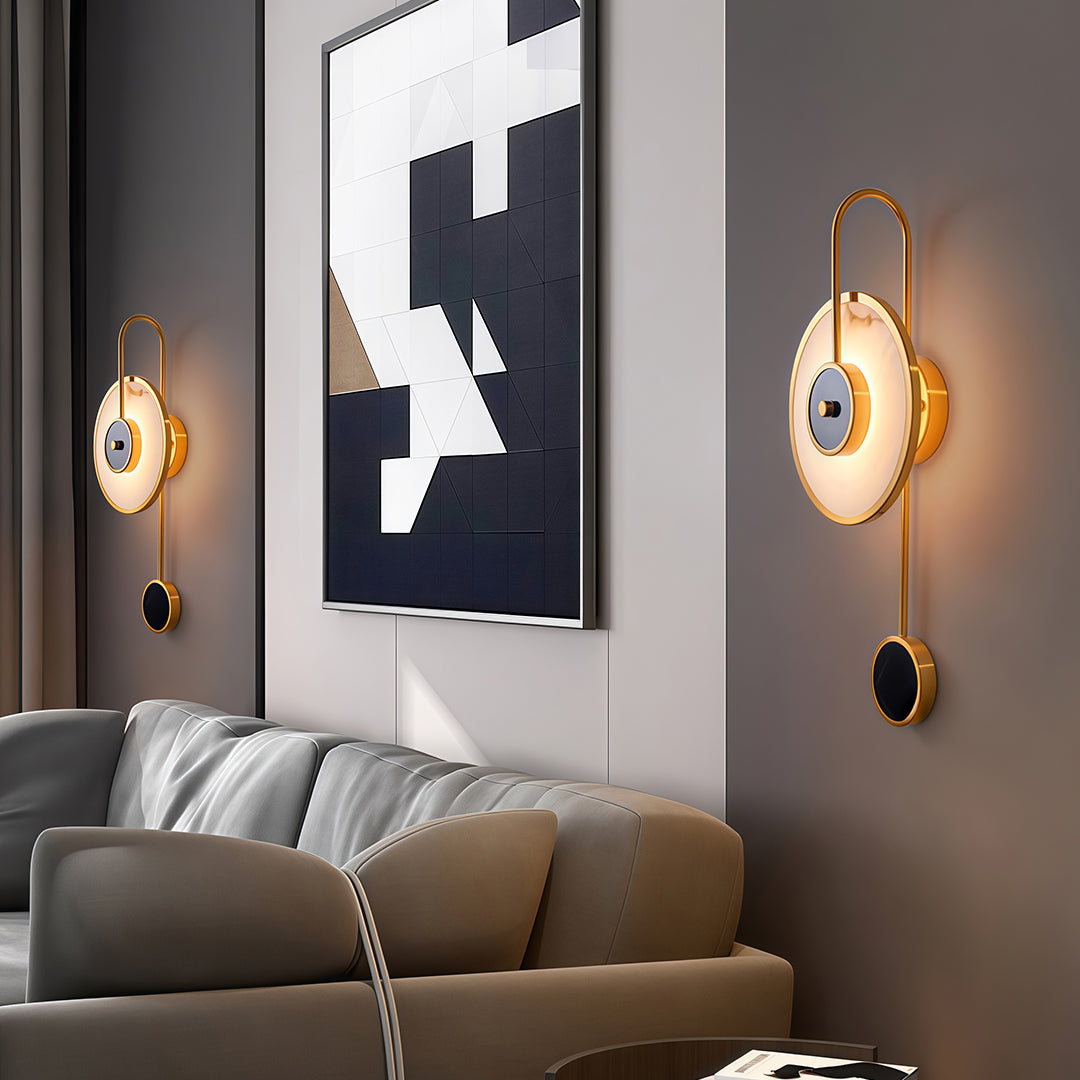 Marble wall light creating sophisticated ambiance in modern bedroom with circular golden glow effect