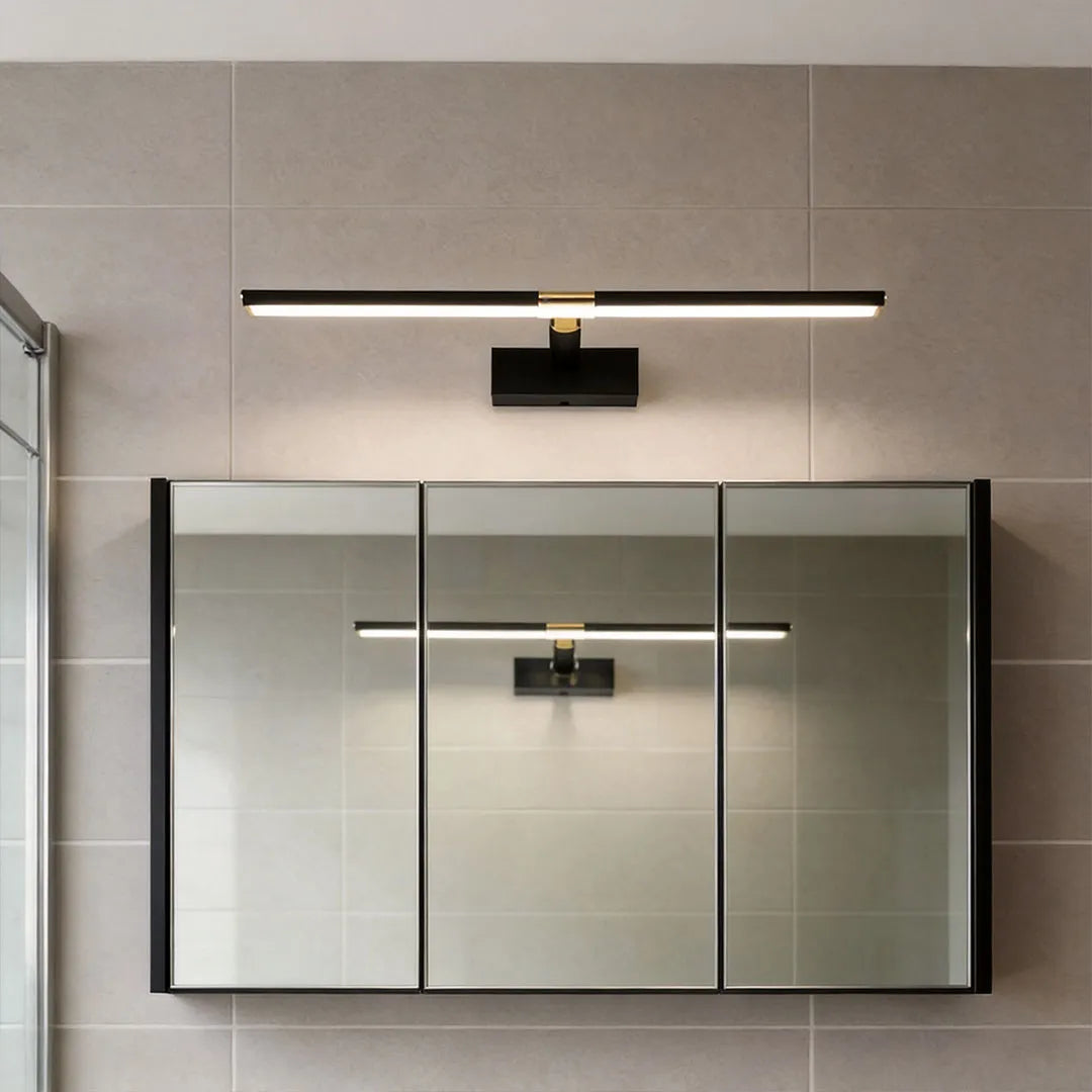 Master bathroom vanity lights installed above a wide mirrored cabinet in a modern gray bathroom.