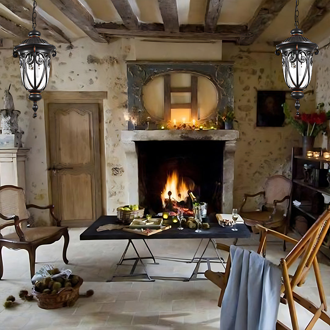 Matching hanging lanterns flanking fireplace in rustic interior with stone walls and wooden beams